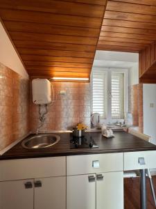 a kitchen with a sink and a counter top at Guest House Katić in Dubrovnik