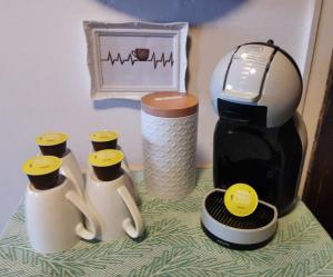 a table with a coffee maker and three coffee makers at HOCHDÜRRNBERG WATZMANN Doppelzimmer mit Bad Balkon Gästeküche - Frühstück optional in Dürrnberg