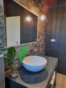 a bathroom with a large bowl sink on a counter at Thasos Bespoke Haven - Meltemi Summer Retreat! in Limenaria