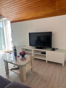 a living room with a tv and a coffee table at Guest House Katić in Dubrovnik