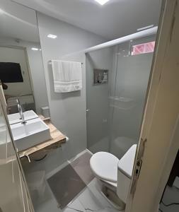 a bathroom with a toilet and a sink and a shower at Casa de Praia Tibau-RN in Tibau