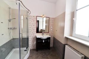 a bathroom with a sink and a mirror at Hotel Pod Jeleniem in Sobótka +48 photos