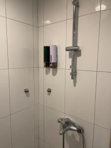 a shower with a faucet in a bathroom at Yiting Hotel in Kaohsiung