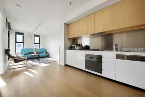 a kitchen with a couch and a table in a room at Top Location 2 BR Apt Amazing View & Free parking in Melbourne