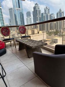 a balcony with a table and chairs and a city skyline at Backpackers zone in Dubai