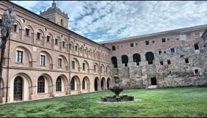 a large building with a fountain in front of it at Albergue de peregrinos San Cipriano in Ayegui