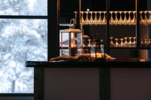 a table with glasses and a candle on it at Lapland Hotels Ylläskaltio in Äkäslompolo