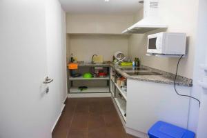 a small kitchen with a sink and a microwave at Albergue Municipal San Cipriano in Ayegui