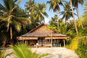 a small hut on the beach with palm trees at Tailana Island Pulau Banyak in Alaban