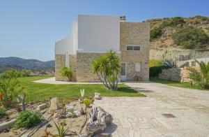a stone house with a hill in the background at Villa Kalimera swimming pool Pitsidia Matala Komos in Pitsidia