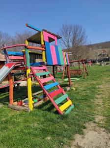 a playground with a colorful slide in the grass at Holiday home in Kereki - Balaton 48110 in Kereki