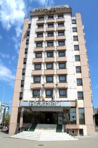 a hotel building with stairs in front of it at Hotel Egreta in Tulcea