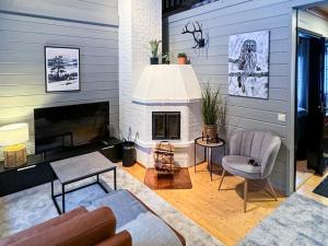 a living room with a couch and a fireplace at Holiday Apartments Halla-Ukko 3 in Komula