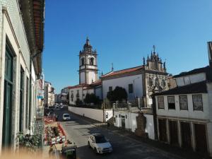 a city street with a clock tower and a church at Guest House Sir Manuel - Unidade São Vicente in Braga