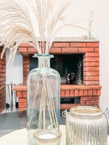 a glass vase with grass in it on a table at Paradiso Privato di Modolo in Modolo