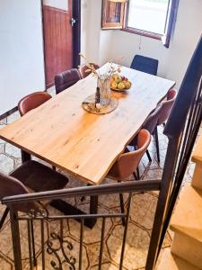 a wooden table in a room with chairs at Paradiso Privato di Modolo in Modolo