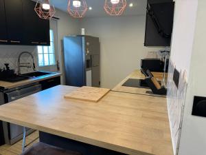 a kitchen with a wooden counter top and a blue refrigerator at Jolie maison avec Salon Cinéma in Mouy