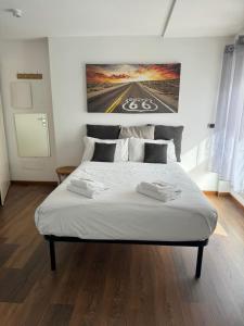 a bedroom with a large bed with two towels on it at Trastevere Studio Flat - Zen Real Estate in Rome