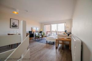 a living room with a couch and a table at Rampart View in Gosport