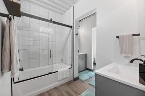 a white bathroom with a tub and a sink at Crate Escape at Terry Peak in Lead +27 photos