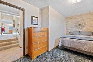 a bedroom with a large bed and a dresser at Farmhouse Ranchette - Horses Welcome in Belle Fourche