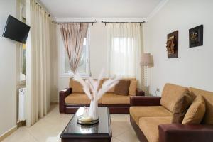 a living room with a couch and a table at Mandani Villa Luxury Apartments in Limenas