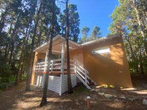 a tiny house in the woods with the door open at Casa Libertad in Mar de las Pampas