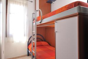 a bunk bed room with two bunk beds in a room at Apartments Baunei in Baunei