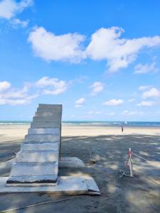 a group of steps on a beach with the ocean at Le'Coco Homestay in Tiara Desaru Residence in Desaru