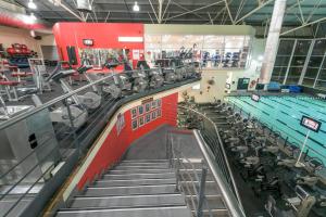 an empty gym with a swimming pool and treadmills at 625 on Marine - 5 min from beach in Durban