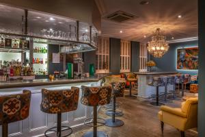 a bar at a restaurant with bar stools at The Kings Harbour Hotel in Christchurch