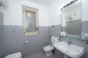 a white bathroom with a sink and a toilet at Casa Anna Amalfi coast in Amalfi