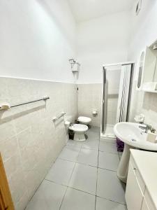 bagno bianco con servizi igienici e lavandino di Casa Levante a Cefalù