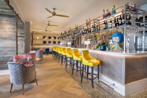a bar with yellow stools and a counter at Harbour Hotel Padstow in Padstow