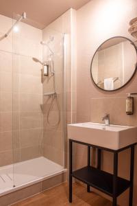 W łazience znajduje się umywalka i prysznic. w obiekcie The Originals City, Hôtel Alteora, Poitiers Site du Futuroscope (Inter-Hotel) w mieście Chasseneuil-du-Poitou