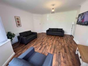 a living room with two couches and a couch at House in London near O2, Greenwich & Canary Wharf in Eltham