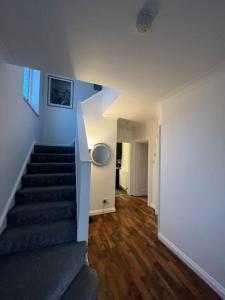 a hallway with a staircase in a house at House in London near O2, Greenwich & Canary Wharf in Eltham