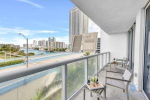 a balcony with a swimming pool and a view of the city at Modern Condo - Amazing Pool - Gym - Balcony in Hallandale Beach +47 photos