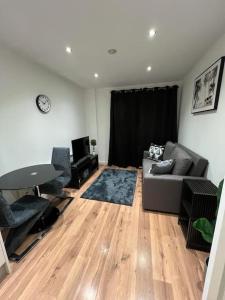 a living room with a couch and a table at cosy and prime location in Sheffield