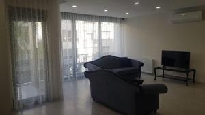 a living room with a chair and a television at 6 Central Location, Close To Beaches And Anywhere in Antalya