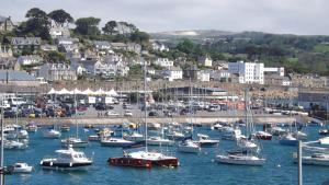 a bunch of boats are docked in a harbor at Sunny Corner - Bright, Spacious Apartment with Harbour Views - 102 in Penzance