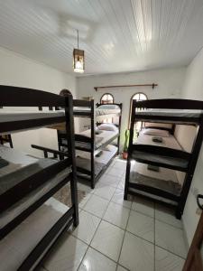 a room with a bunch of bunk beds at Aluê Hostel in Arraial d'Ajuda