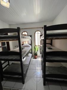 a room with several bunk beds in it at Aluê Hostel in Arraial d'Ajuda