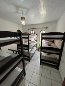a room with a bunch of bunk beds in it at Aluê Hostel in Arraial d'Ajuda