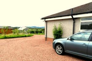 a car parked in front of a house at Annexe Meadowbank Dumfries in Dumfries
