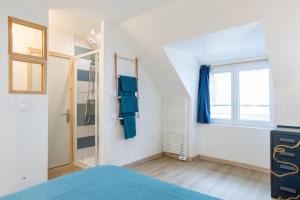 um quarto com uma cama e uma janela em Duplex de charme em Le Guilvinec