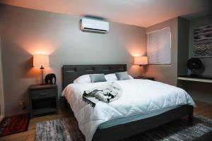 a bedroom with a large bed with a tv on the wall at City Lights 143 in Tumon