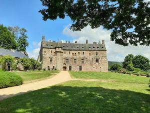 an old castle on a grassy field at Chambres d'hôtes de Ty Guen in Trédarzec