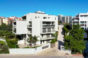 an aerial view of a white apartment building at Oásis Mar - Beach and Sun House in Portimão