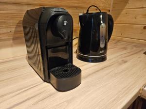 a coffee maker sitting on top of a counter at Domek drewniany Krokus in Witów